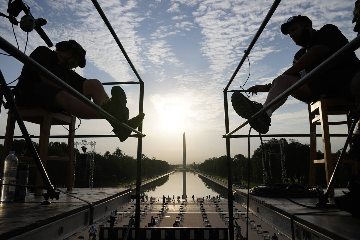 The early morning sun rises over the Washing ton Monument and the Reflecting Pool as final prep ...