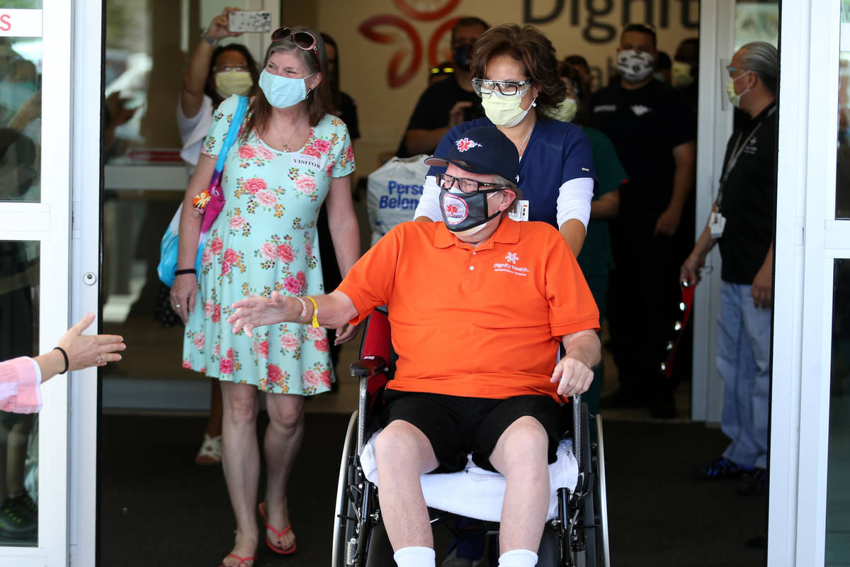 Paramedic John Foster, center, a recovered COVID-19 patient, with his girlfriend Laurie Matthew ...