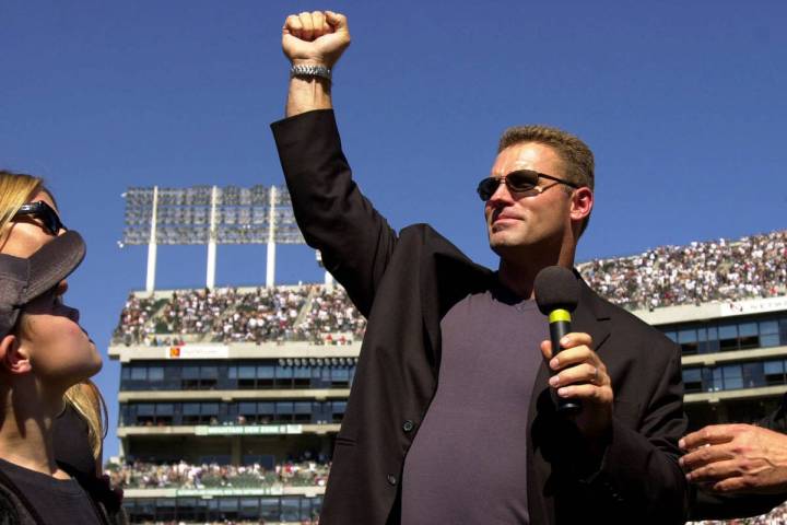 Former Oakland Raiders defensive lineman Howie Long holds up his arm at halftime during the Rai ...