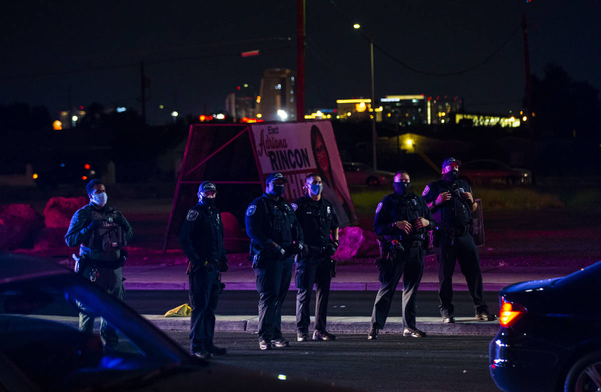 North Las Vegas police look on as protesters stop traffic during a rally against police brutali ...