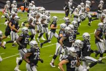 Las Vegas Raiders QB Derek Carr (4) runs with teammates during warm ups for a scrimmage at Alle ...