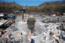 Artist Marcia Ritz, 77, leaves after looking through the rubble of her manufactured home at the ...