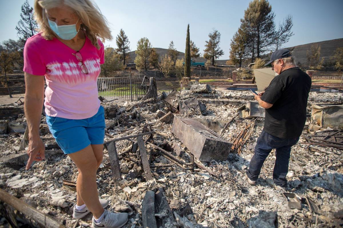 Carol and Bruce Schafer look over what remains of their home along Cantelow Road that was destr ...