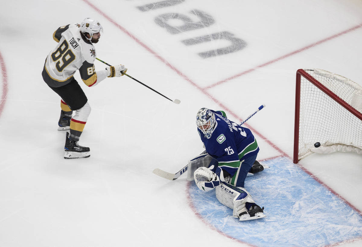 Vegas Golden Knights right wing Alex Tuch (89) scores on Vancouver Canucks goaltender Jacob Mar ...
