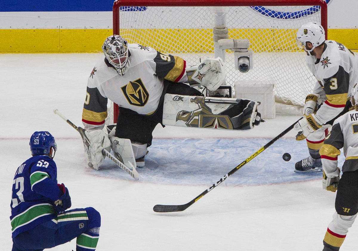 Vegas Golden Knights goalie Robin Lehner (90) makes a save on Vancouver Canucks' Bo Horvat (53) ...