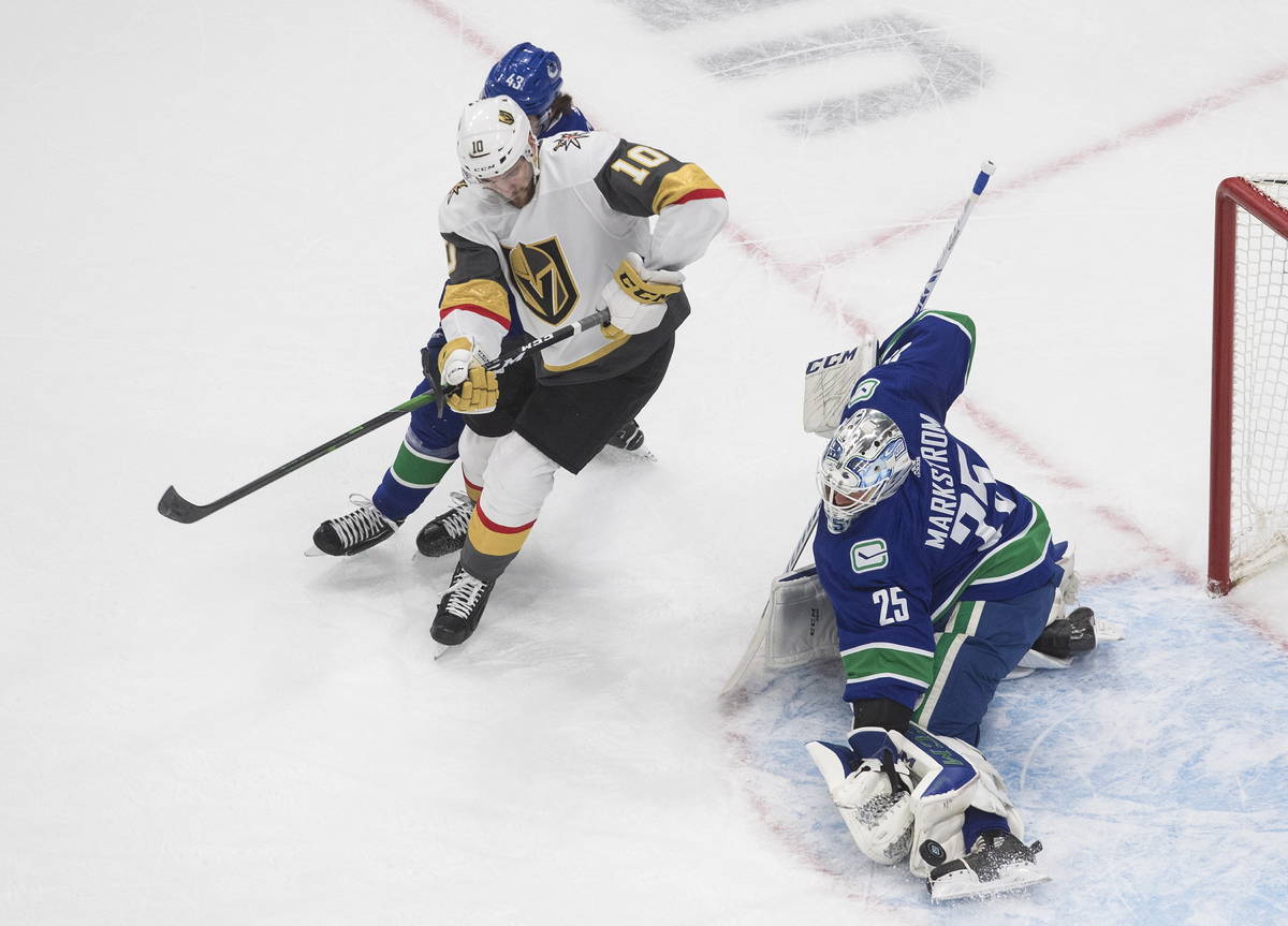 Vegas Golden Knights' Nicolas Roy (10) is stopped by Vancouver Canucks goalie Jacob Markstrom ( ...