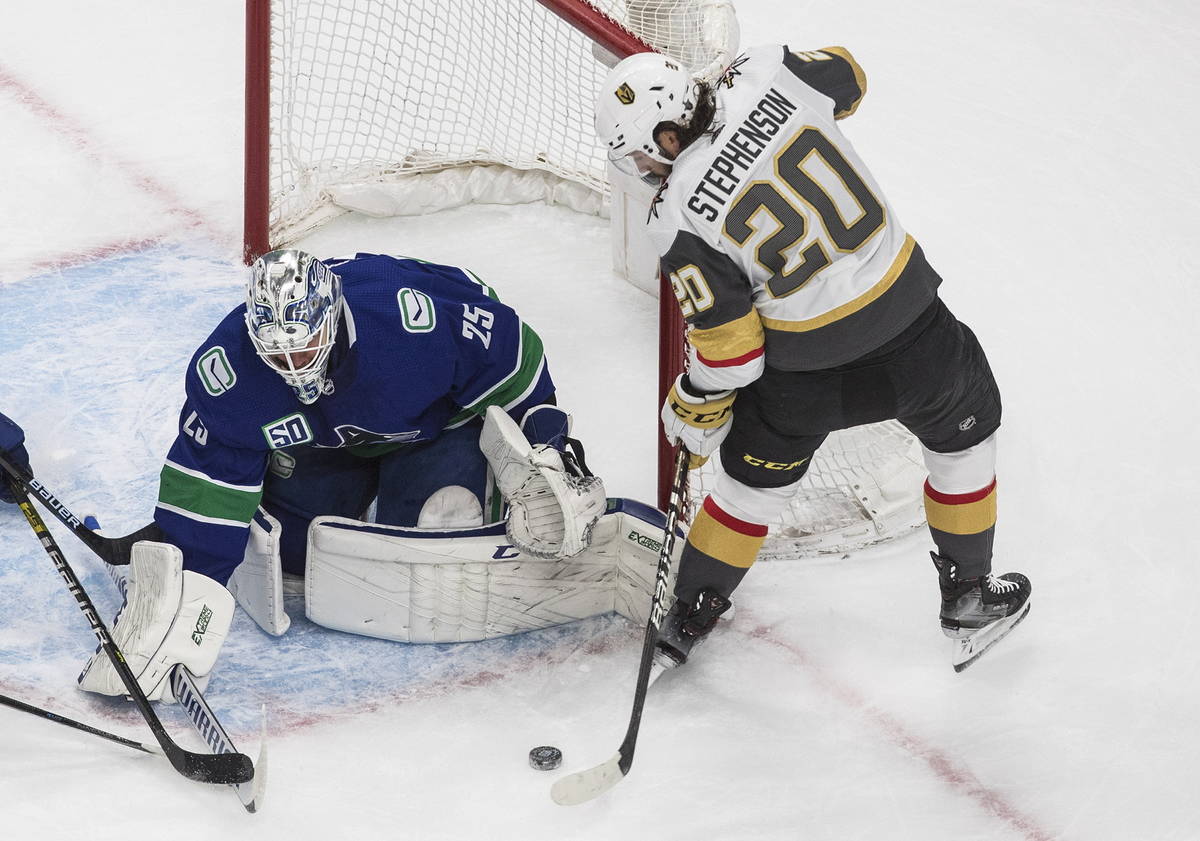 Vegas Golden Knights' Chandler Stephenson (20) is stopped by Vancouver Canucks goalie Jacob Mar ...
