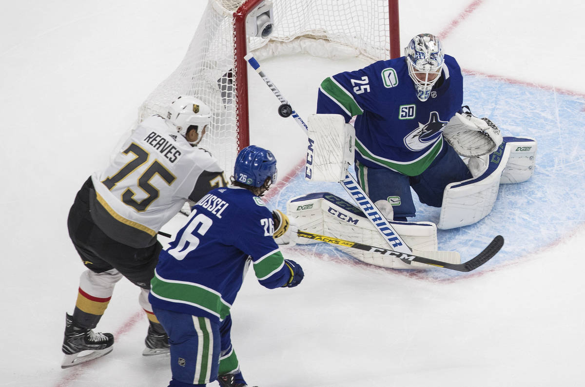 Vegas Golden Knights' Ryan Reaves (75) is stopped by Vancouver Canucks goalie Jacob Markstrom ( ...