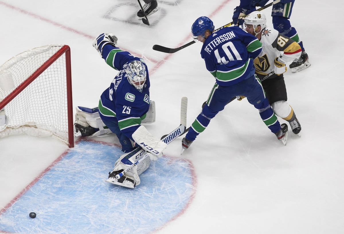 Vegas Golden Knights' Jonathan Marchessault (81) is stopped by Vancouver Canucks goalie Jacob M ...