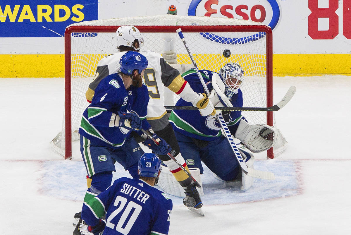 Vegas Golden Knights' Alex Tuch (89) is stopped by Vancouver Canucks goalie Jacob Markstrom as ...