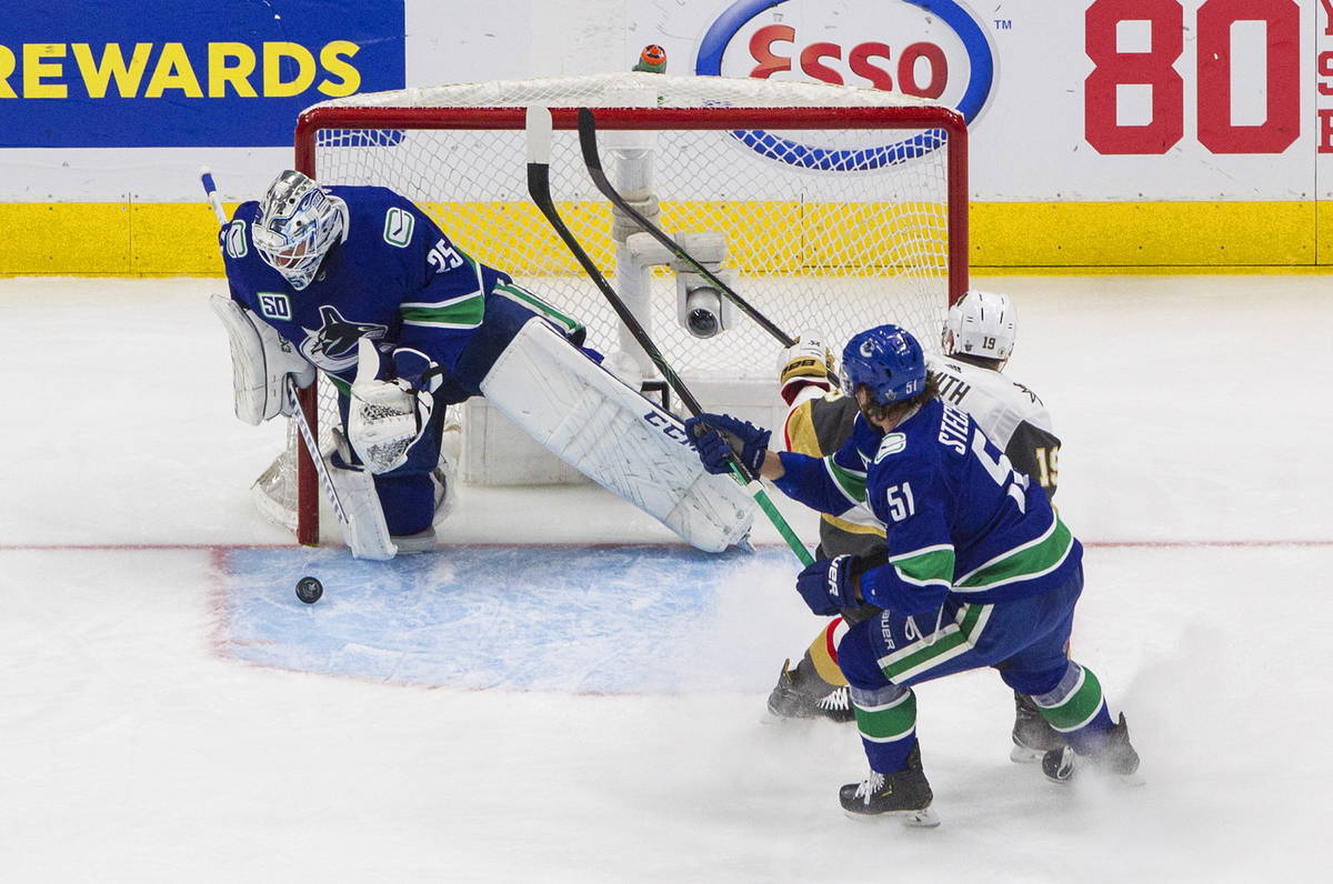Vegas Golden Knights' Reilly Smith (19) is stopped by Vancouver Canucks goalie Jacob Markstrom ...