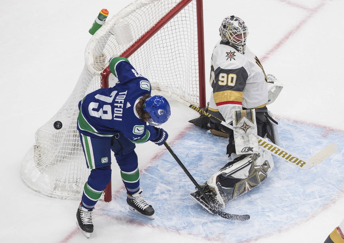 Vegas Golden Knights goalie Robin Lehner (90) makes a save as Vancouver Canucks right wing Tyle ...