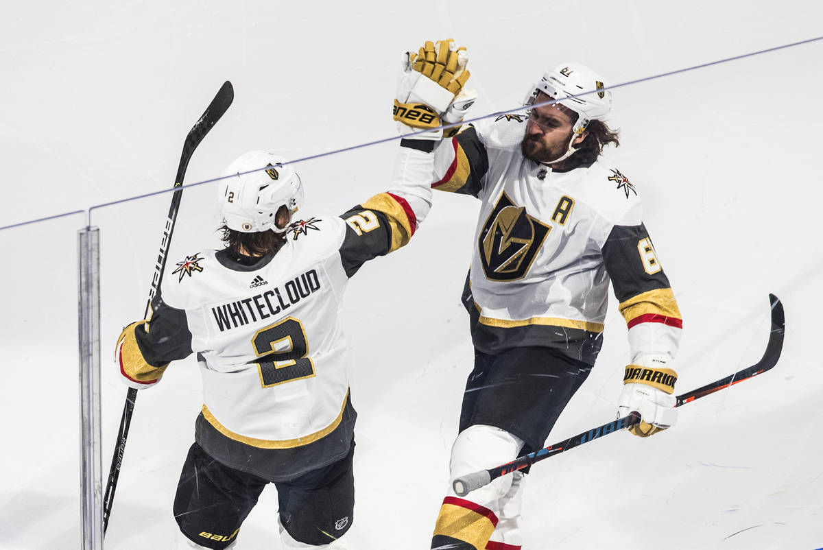Vegas Golden Knights defenseman Zach Whitecloud (2) celebrates his goal with teammate right win ...