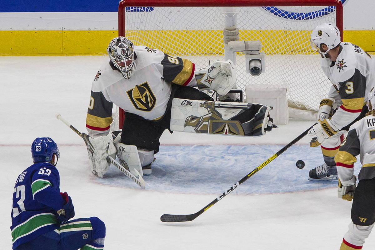 Vegas Golden Knights goalie Robin Lehner (90) makes a save on Vancouver Canucks' Bo Horvat (53) ...