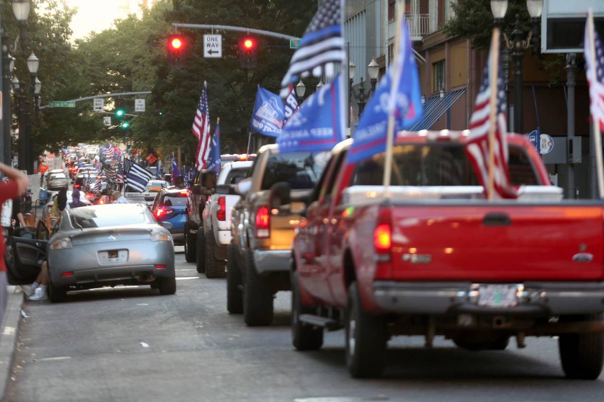 A caravan of supporters of President Donald Trump drive in downtown Portland, Ore., Saturday, A ...