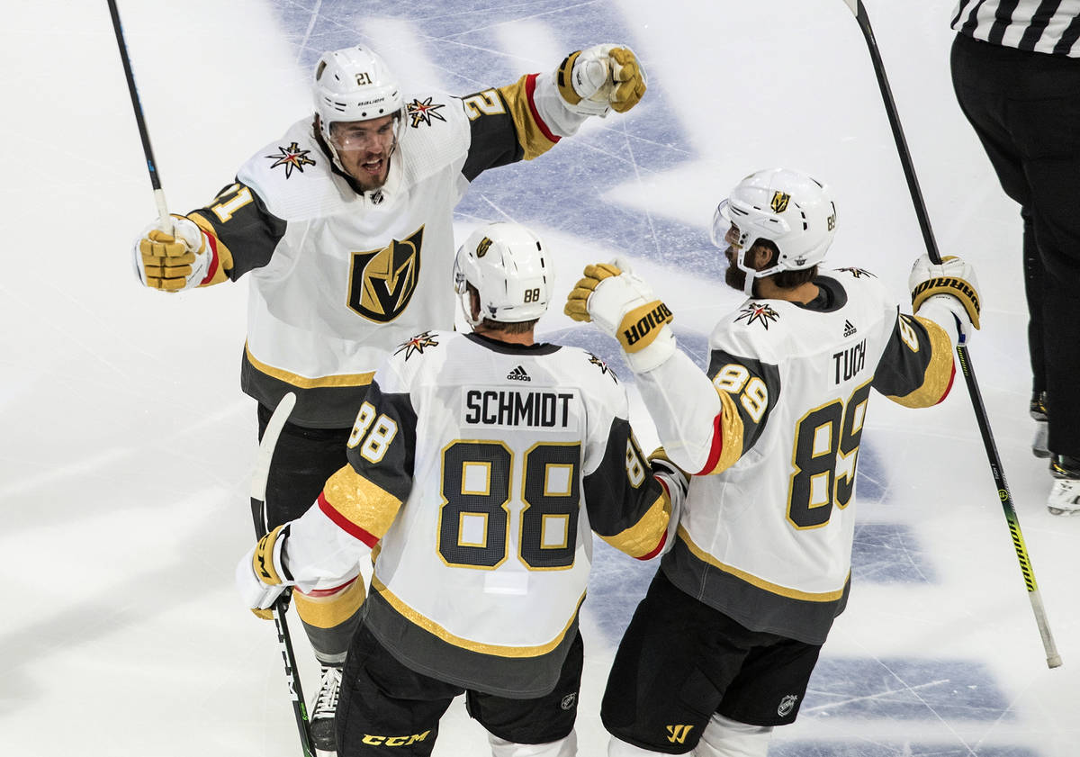 Vegas Golden Knights' Nick Cousins (21), Nate Schmidt (88) and Alex Tuch (89) celebrate a goal ...