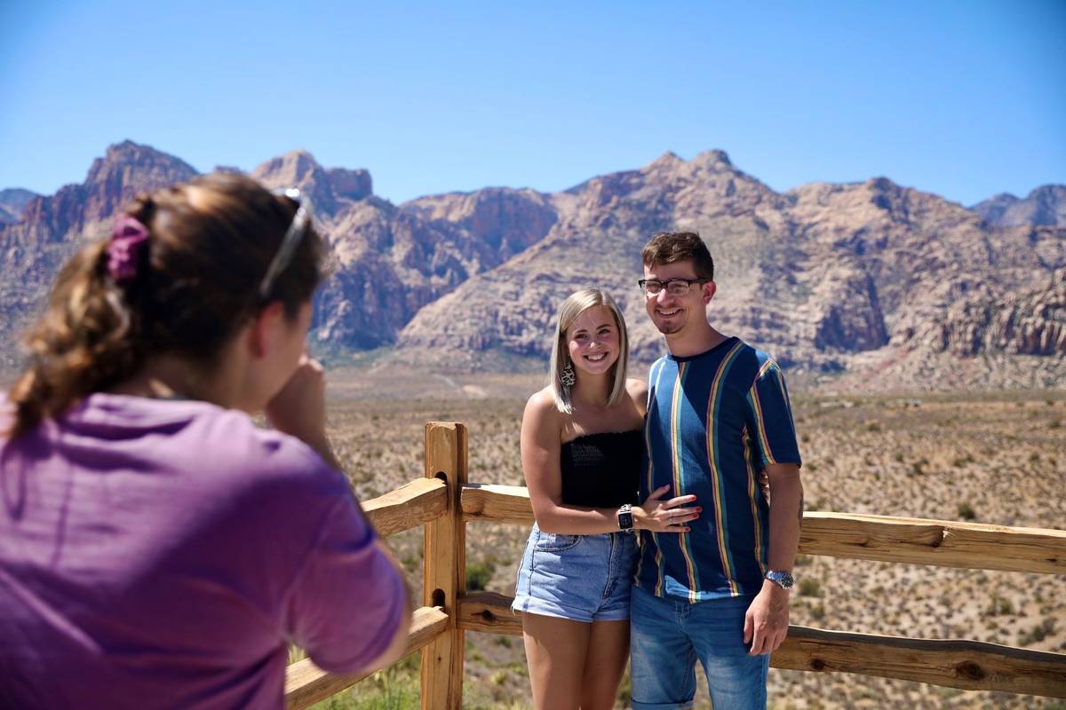 Brianna Shultz, from left, of Las Vegas, takes a photo of her friends Jennah Smith and Cole Len ...