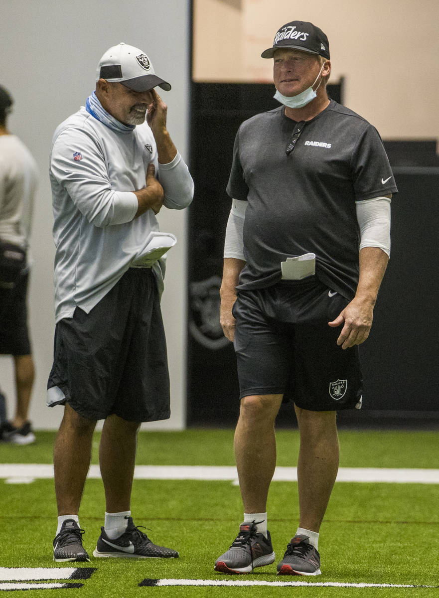 Las Vegas Raiders head coach Jon Gruden, right, jokes with special teams coordinator Rich Bisac ...