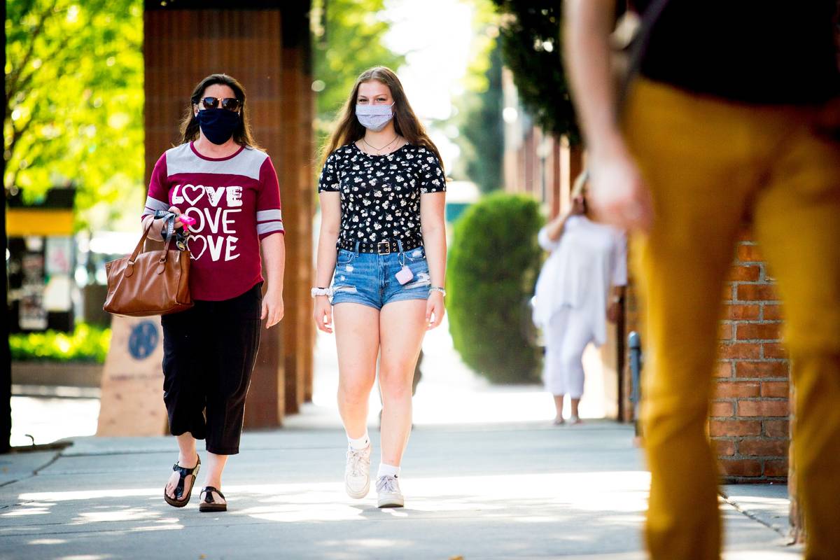 Rebecca Layton and her daughter Delaney Layton, both of Vancouver, Washington, wear face masks ...