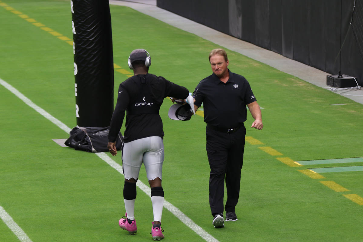 Las Vegas Raiders head coach Jon Gruden, right, greets cornerback Prince Amukamara prior to a t ...
