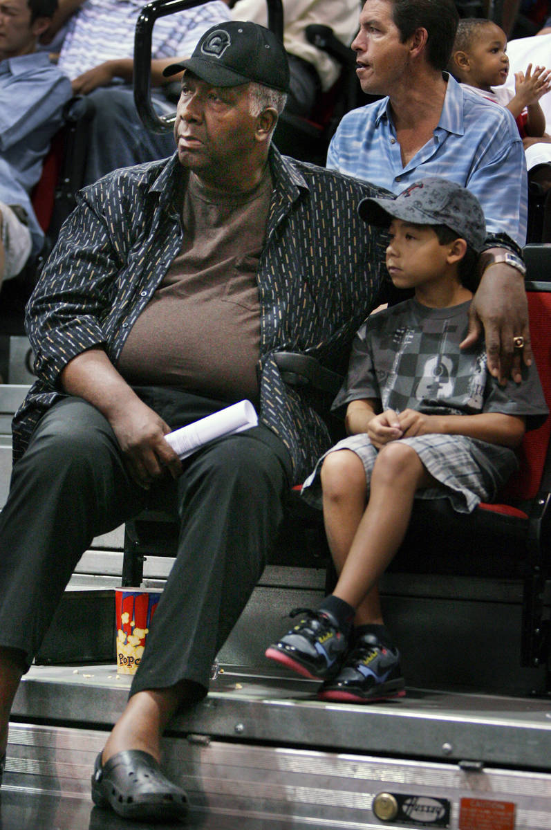 Former Georgetown basketball coach John Thompson, left, watches the Sacramento Kings play the T ...