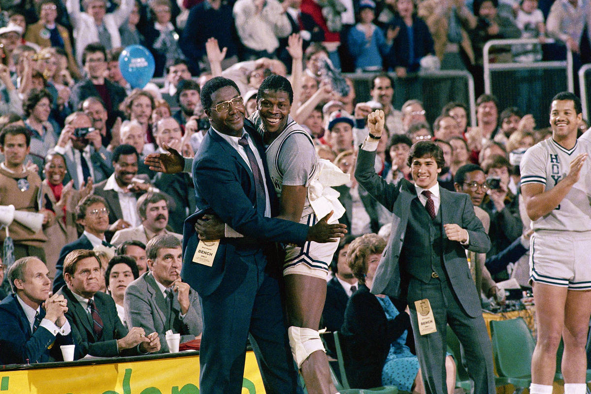 FILE - In this April 2, 1984, file photo, Georgetown head coach John Thompson, left, gives a ha ...