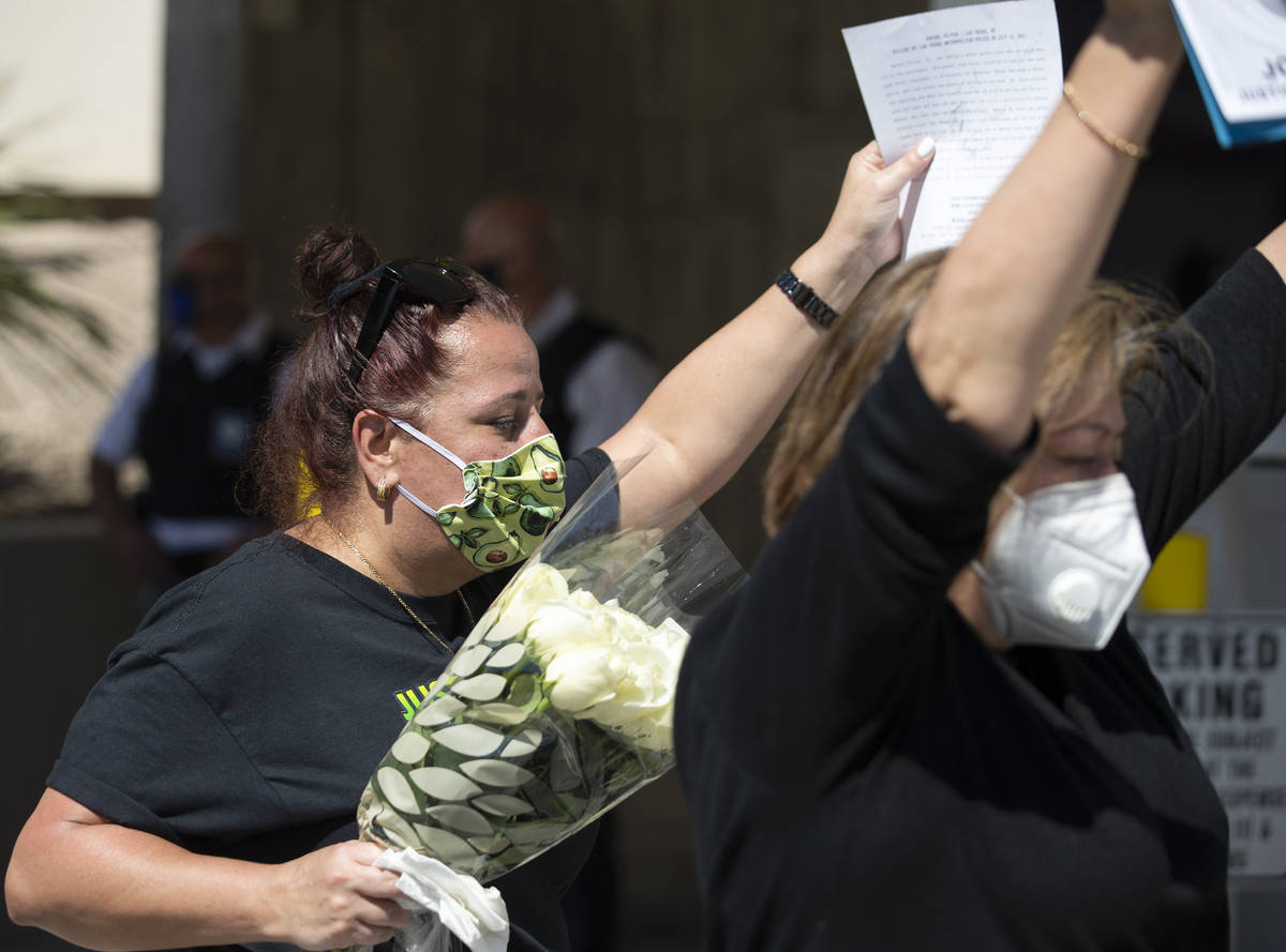 Jazmine Gomez, left, and Alma Chavez, right, hold up a copy of the lawsuit against Las Vegas po ...