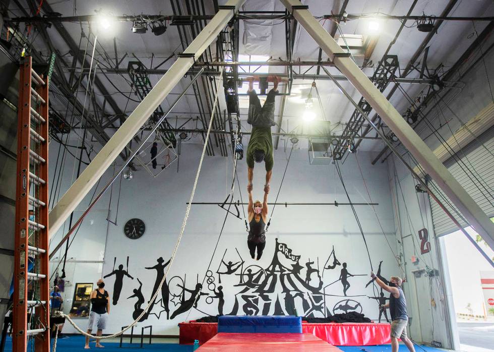 Aerialist-turned-fundraiser Caroline Lauzon rehearses with Felipe Bellomo at Trapeze Las Vegas. ...