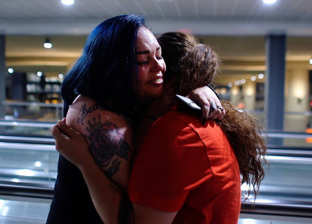 Alisha Burns hugs her sister Amanda Eubanks, whom she hasn't seen in 18 years, at McCarran Inte ...