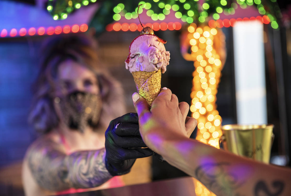 Founder and head creamstress Valerie Stunning hands an ice cream cone called "Baby Stripper" to ...