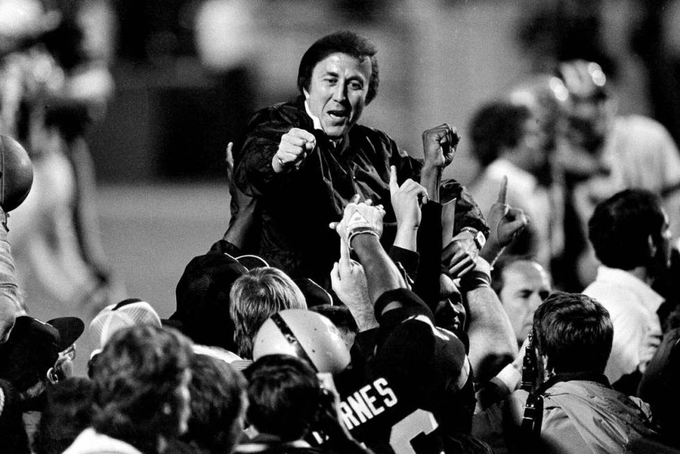 FILE - In this Jan. 23, 1984, file photo, coach Tom Flores gestures to members of the Los Angel ...