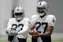 Las Vegas Raiders safety Damarious Randall, left, and cornerback Trayvon Mullen (27) stretch du ...