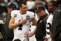 Oakland Raiders quarterback Derek Carr (4) speaks with head coach Jon Gruden on the sideline du ...