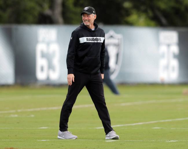 Oakland Raiders general manager Mike Mayock smiles on the field during an offseason training se ...
