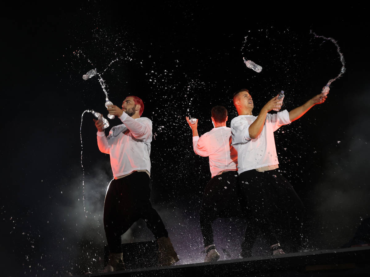 Tony Pezzo, from left, Noah Schmeissner and Doug Sayers juggle open water bottles at Salvage Ci ...
