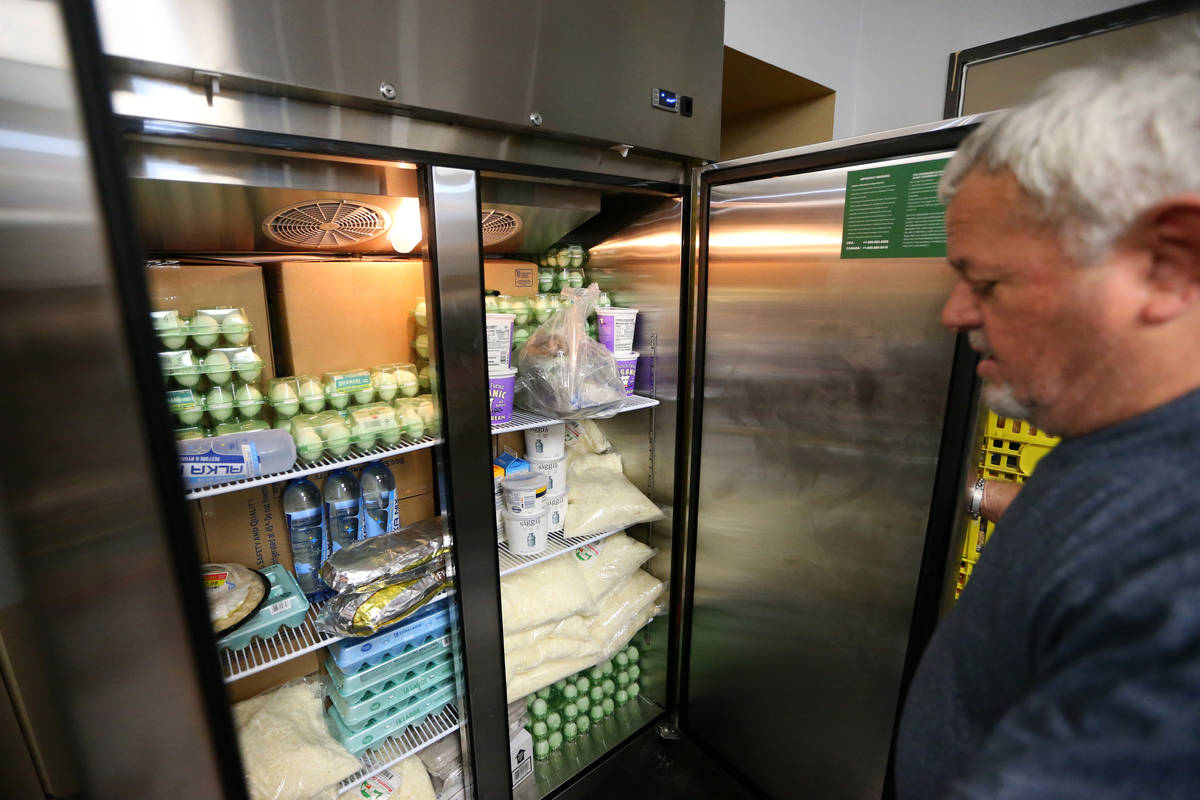 Vic Caruso, director of one food pantry, gives a tour of the City Impact Center food pantry in ...