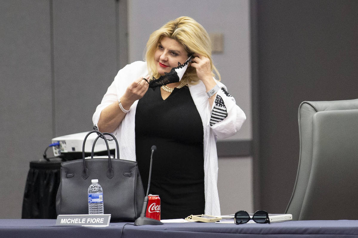 Las Vegas City Councilwoman puts her mask on after leaving it off during a Las Vegas Convention ...