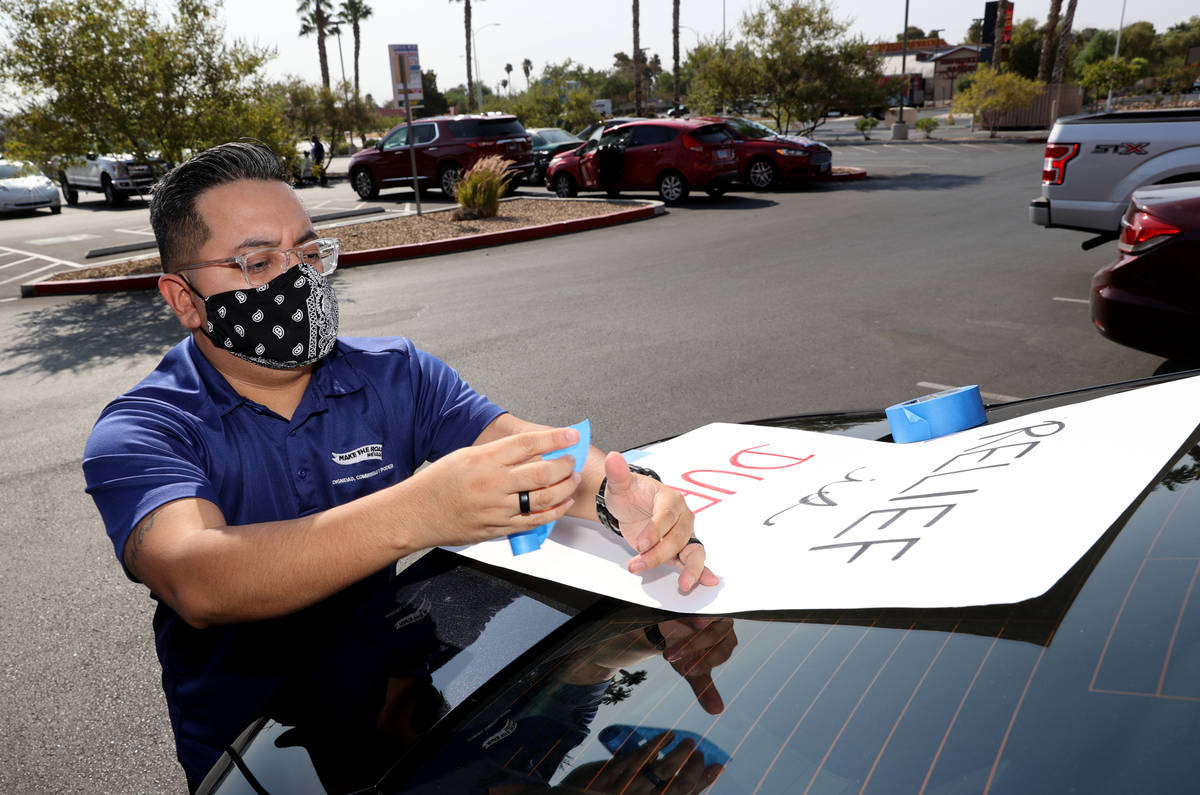 Rico Ocampo of Las Vegas gets his car ready for a caravan at Make the Road Nevada offices in La ...