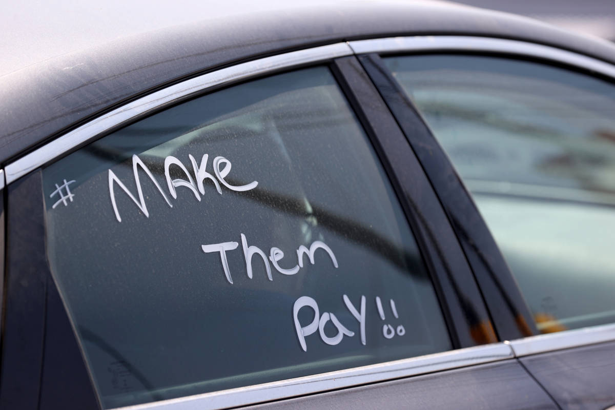 Activists during a car caravan on North Lamb Boulevard in Las Vegas to protest evictions Tuesda ...