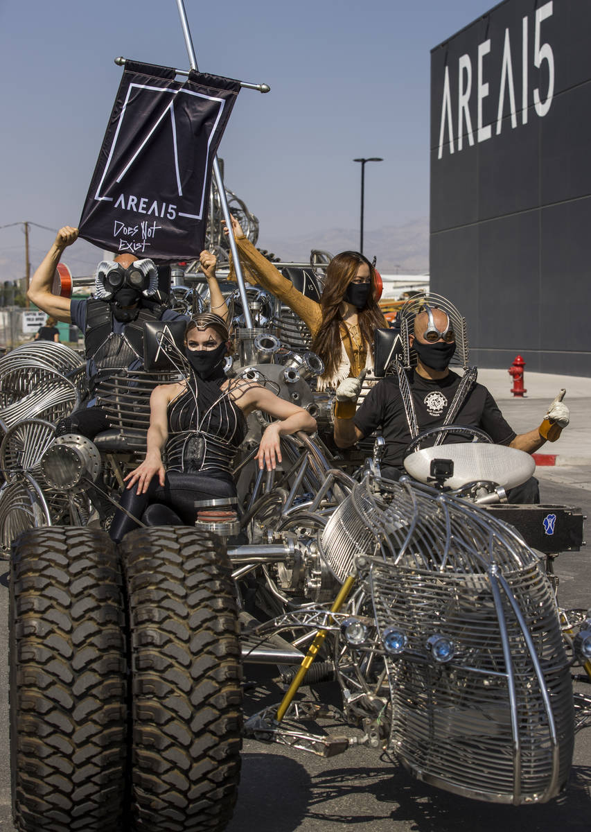 Artist Henry Chang, right, behind the wheel of his kinetic art car Mister Fusion leading a cara ...