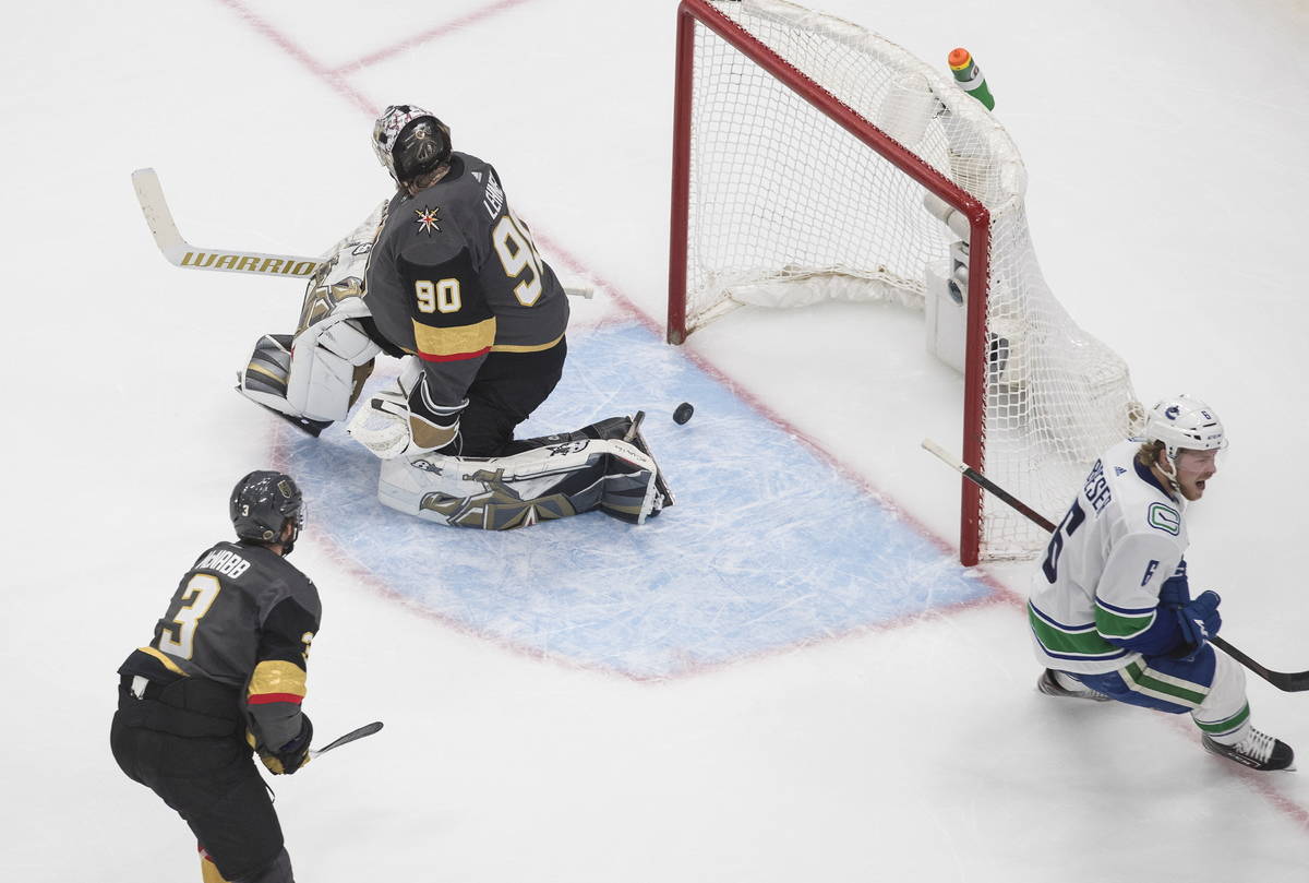 Vancouver Canucks' Brock Boeser (6) scores on Vegas Golden Knights goalie Robin Lehner (90) as ...