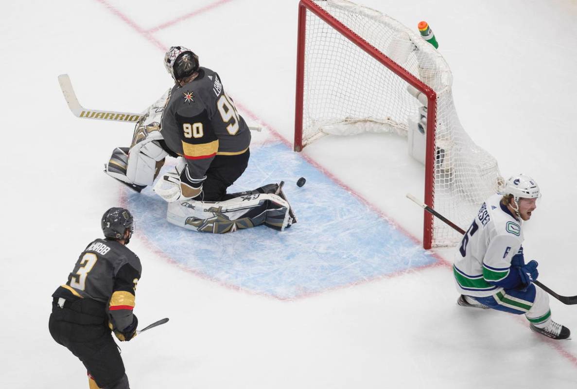 Vancouver Canucks' Brock Boeser (6) scores on Vegas Golden Knights goalie Robin Lehner (90) as ...
