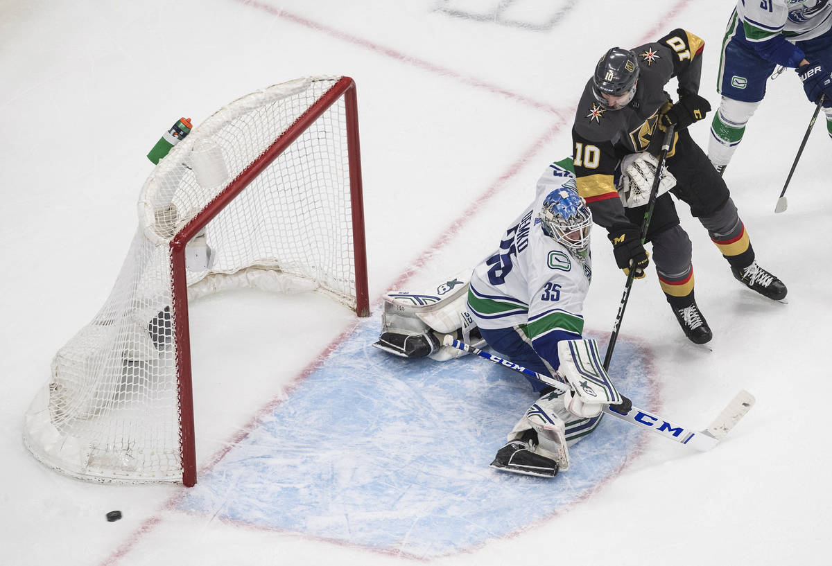 Vancouver Canucks goalie Thatcher Demko (35) makes a save on Vegas Golden Knights' Nicolas Roy ...