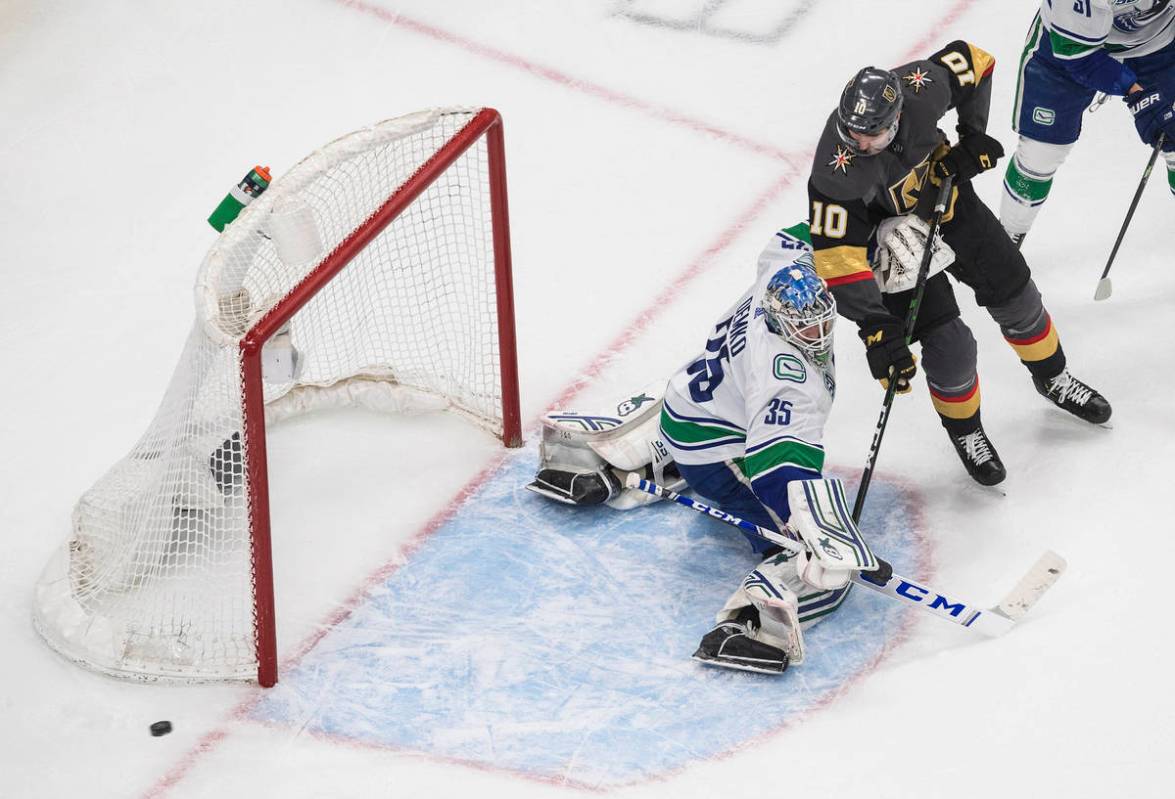 Vancouver Canucks goalie Thatcher Demko (35) makes a save on Vegas Golden Knights' Nicolas Roy ...