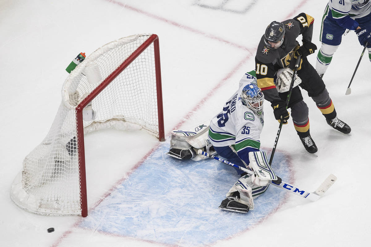 Vancouver Canucks goalie Thatcher Demko (35) makes a save on Vegas Golden Knights' Nicolas Roy ...