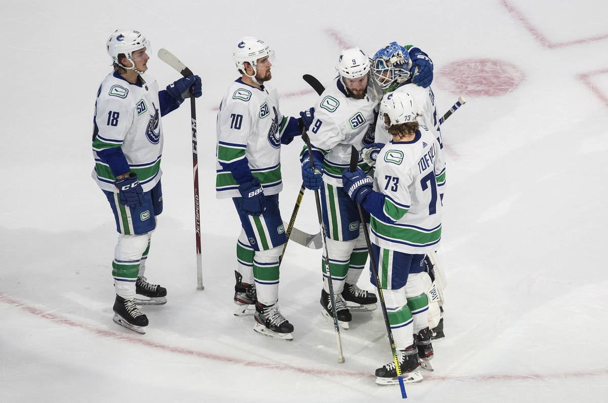 Vancouver Canucks' Jake Virtanen (18), Tanner Pearson (70), J.T. Miller (9), goalie Thatcher De ...