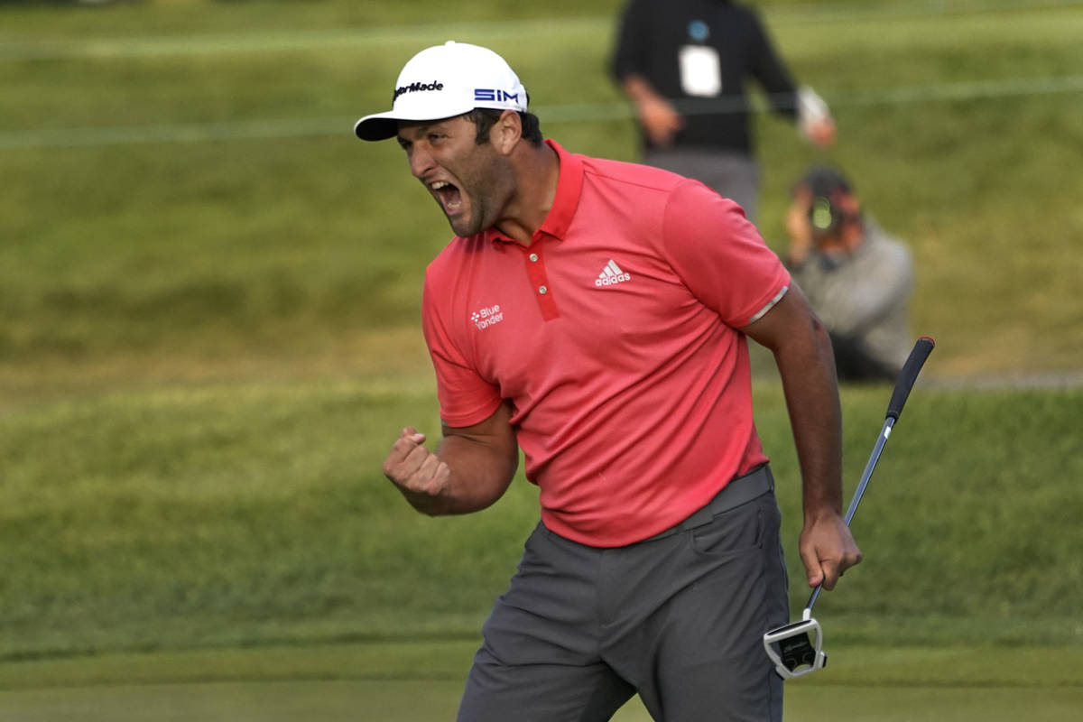 Jon Rahm reacts after making his putt on the first playoff hole during the final round of the B ...