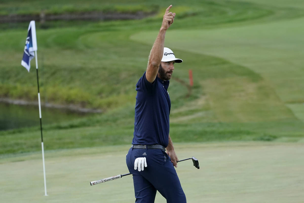 Dustin Johnson reacts after making a birdie putt on the 18th hole during the final round of the ...