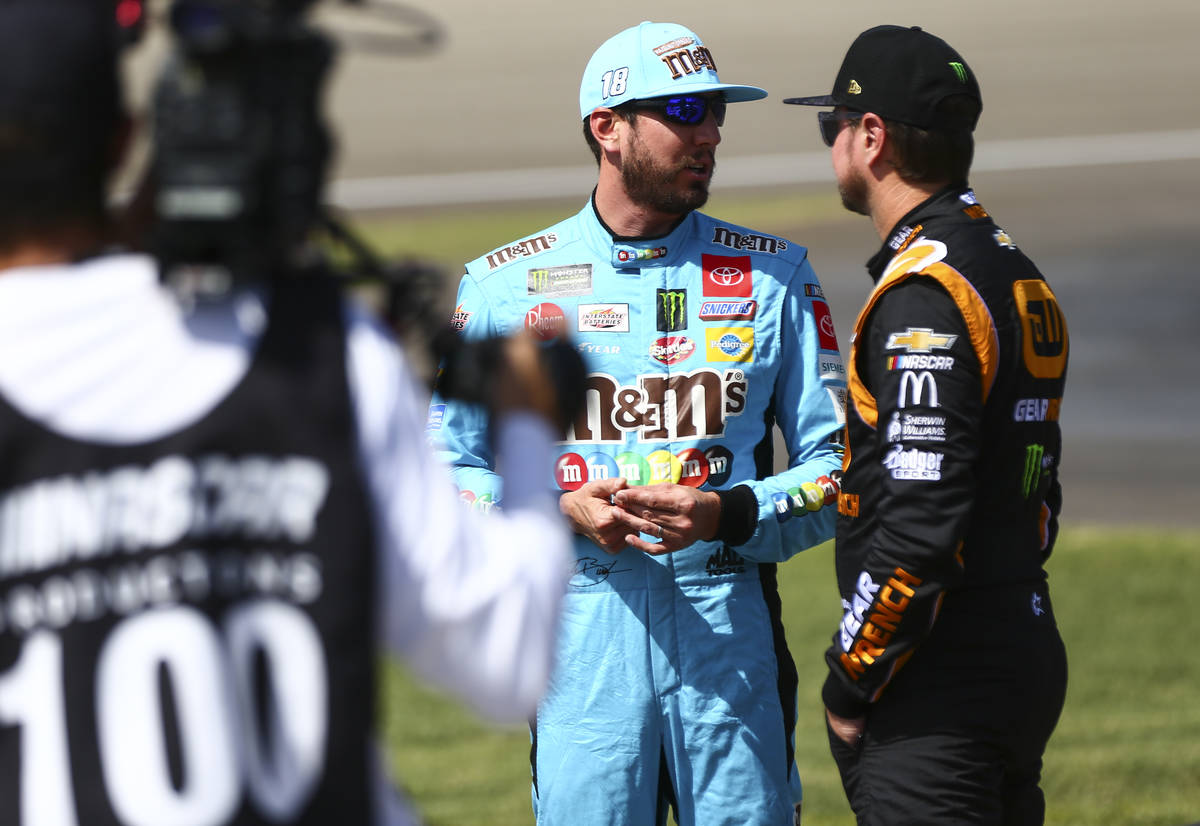 Kyle Busch, left, talks with Kurt Busch before qualifying for the Monster Energy NASCAR Cup Ser ...