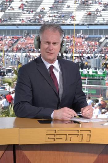 ESPN commentator Kenny Mayne is shown working on a remote studio set during coverage of the Day ...